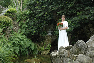 Bridal portrait of young woman in lush garden