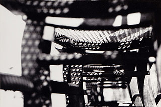 Black and white photo of the bottom of wicker chairs